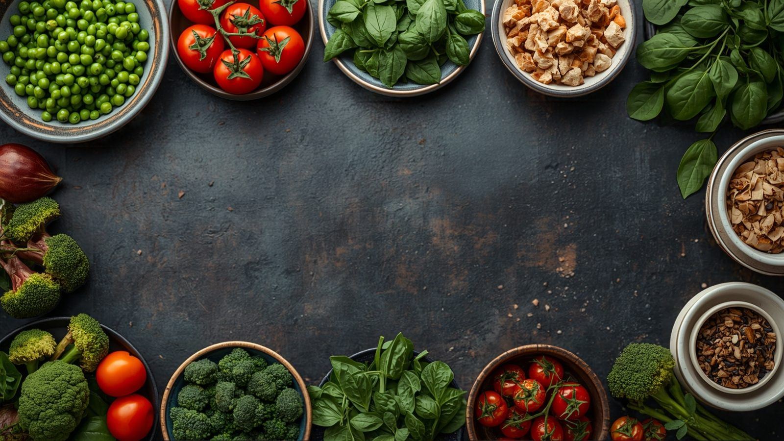 Overhead photo of a dinner table with bowls of peas, cherry tomatoes, broccoli, spinach and roast vegetables on a dark surface